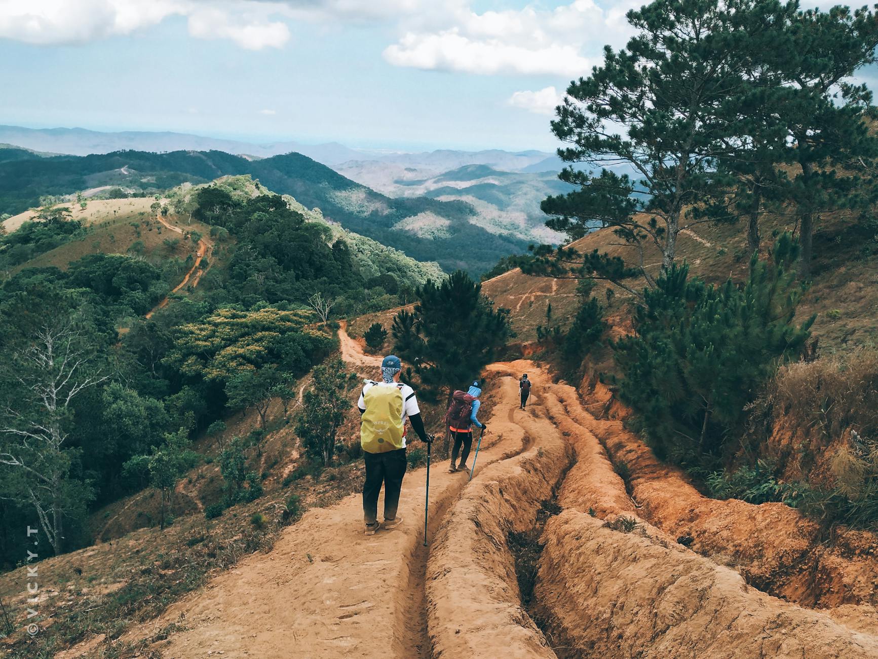 tourists walking along path in mountainous terrain