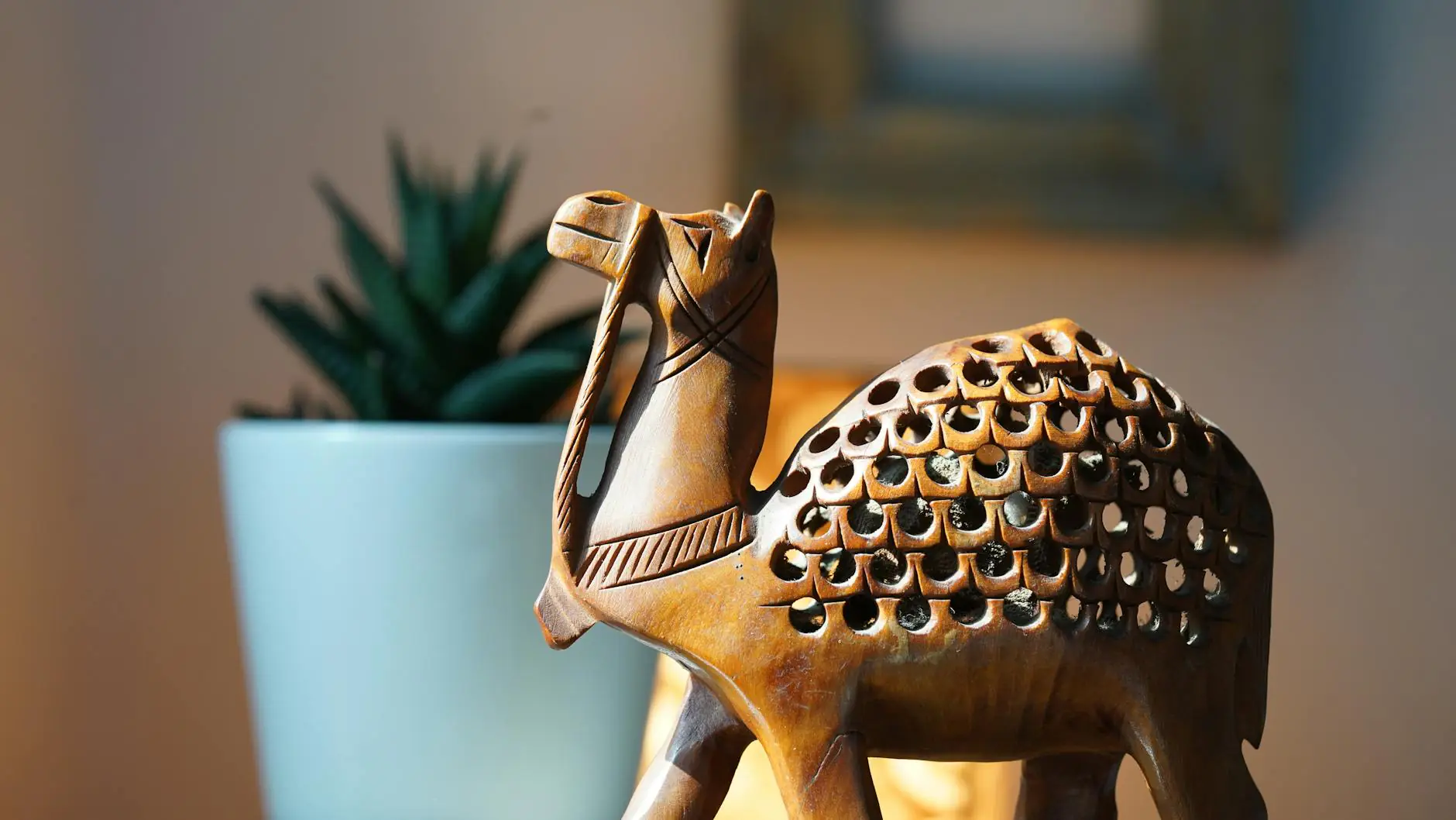 miniature wooden camel sculpture on display