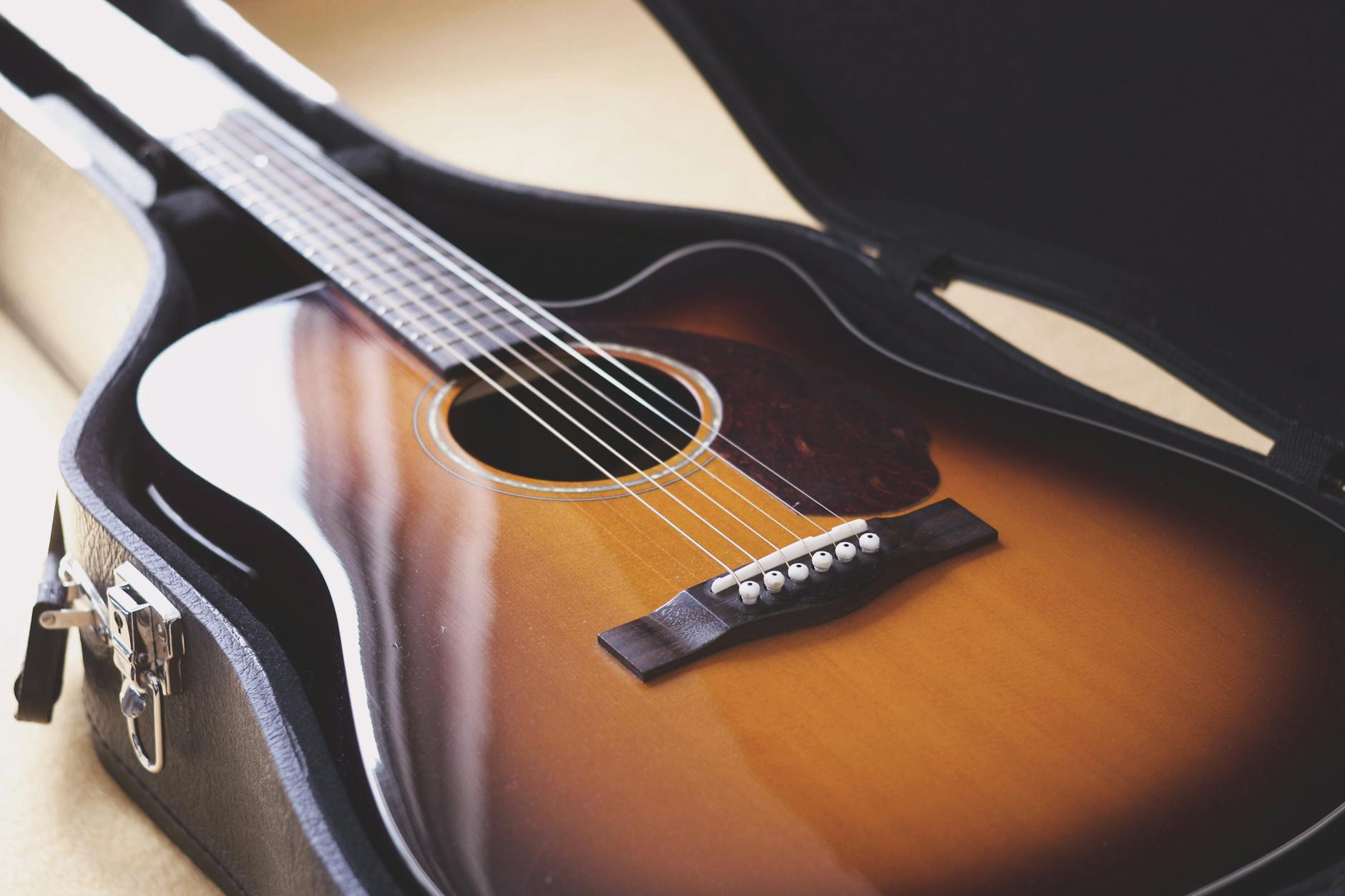 close up of a vintage acoustic guitar in case